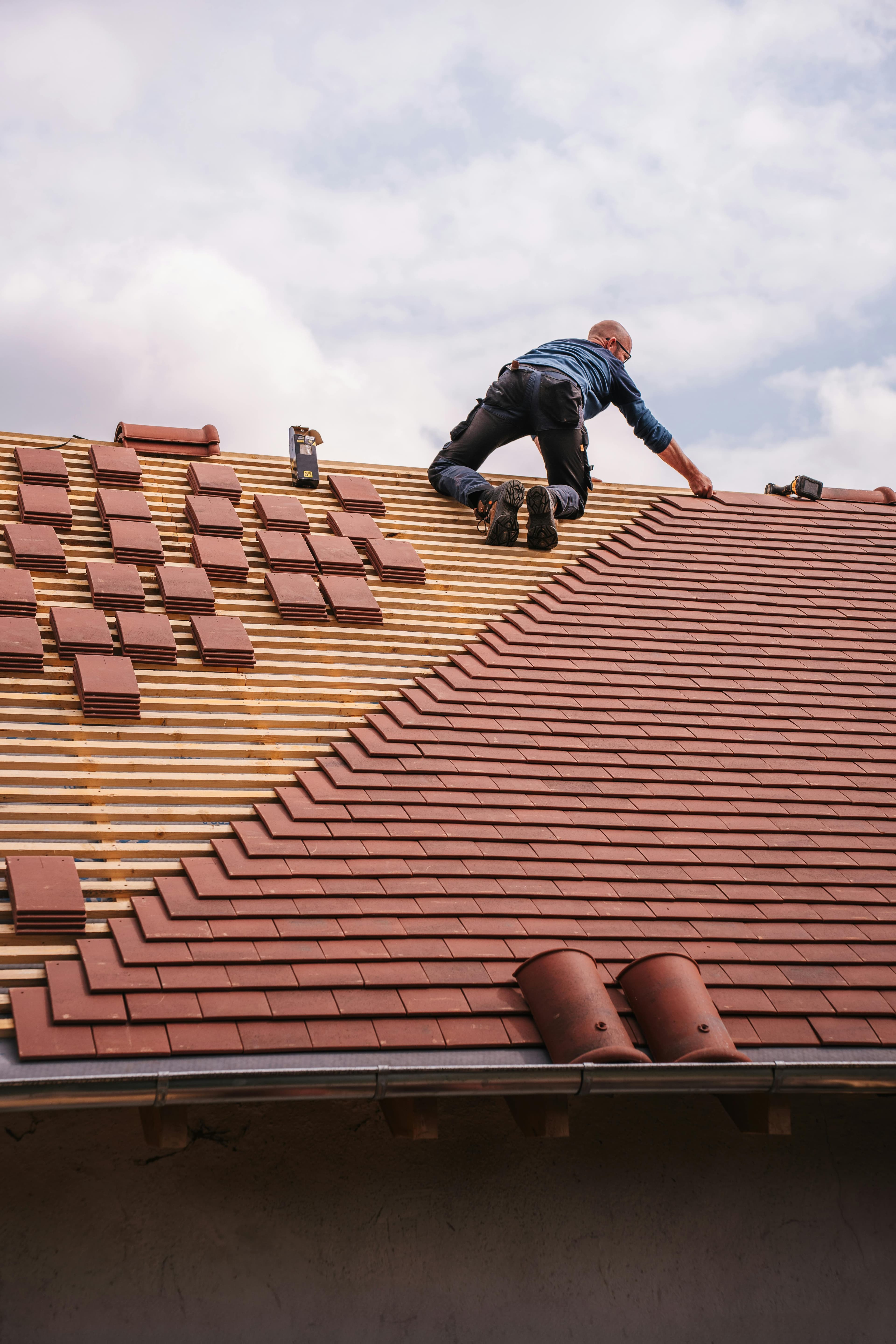 Roofer installing tile on a residential roof
